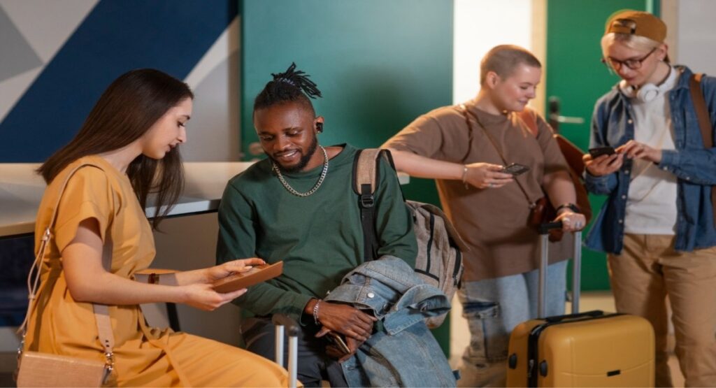 Business travelers with luggage checking their itineraries and travel policy details