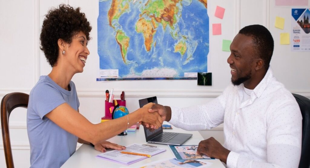 Client and travel manager handshake formalizing crew travel partnership agreement